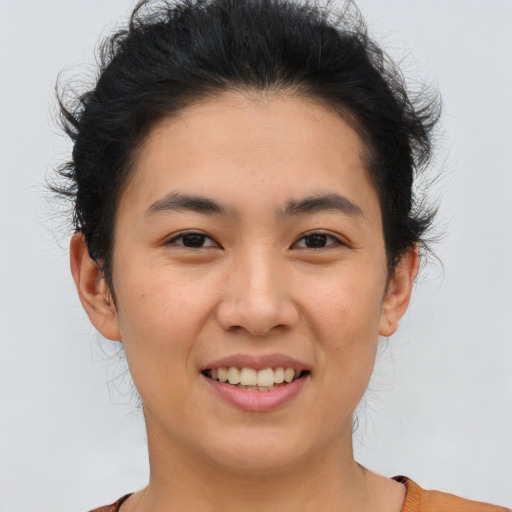 Joyful asian young-adult female with short  brown hair and brown eyes