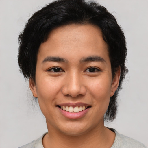 Joyful asian young-adult female with short  black hair and brown eyes