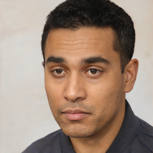 Neutral latino young-adult male with short  black hair and brown eyes