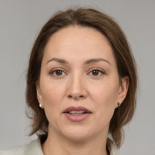 Joyful white adult female with medium  brown hair and brown eyes