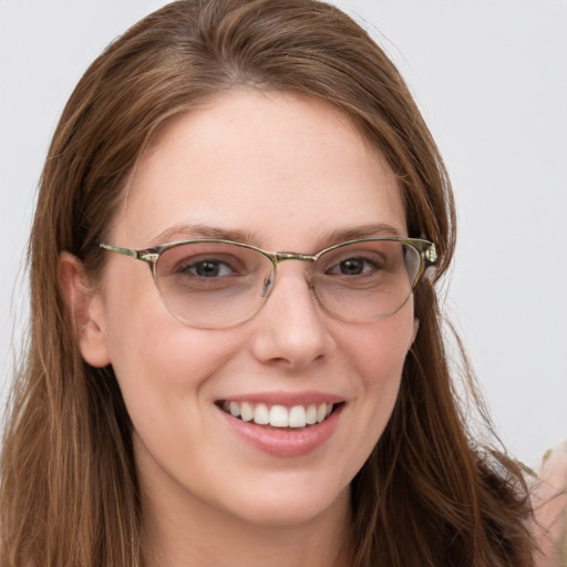 Joyful white young-adult female with long  brown hair and blue eyes