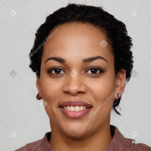 Joyful black young-adult female with short  black hair and brown eyes