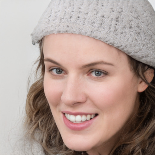 Joyful white young-adult female with medium  brown hair and blue eyes