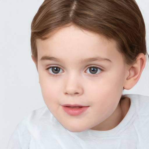 Joyful white child female with short  brown hair and brown eyes