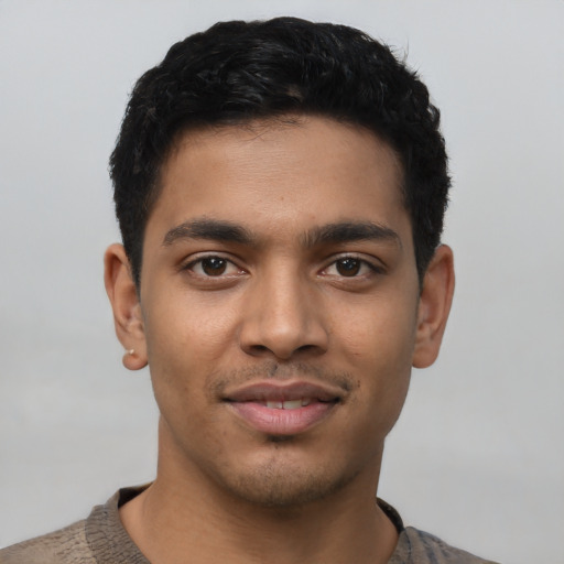 Joyful latino young-adult male with short  black hair and brown eyes