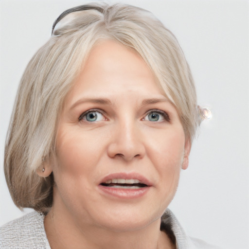 Joyful white adult female with medium  brown hair and blue eyes