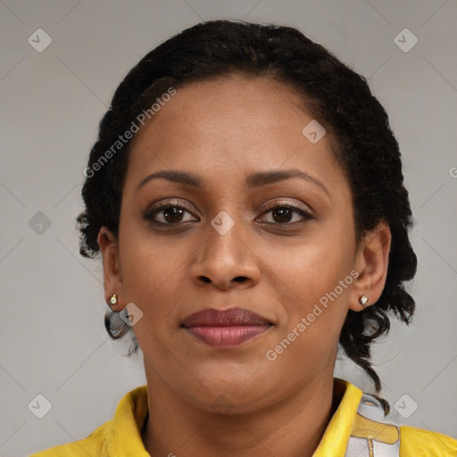 Joyful black young-adult female with short  brown hair and brown eyes