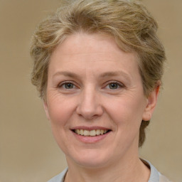 Joyful white adult female with short  brown hair and grey eyes