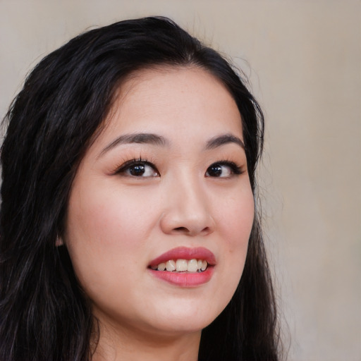 Joyful white young-adult female with long  black hair and brown eyes