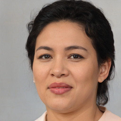 Joyful asian adult female with medium  brown hair and brown eyes