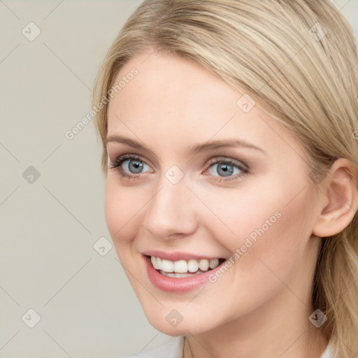 Joyful white young-adult female with long  brown hair and blue eyes