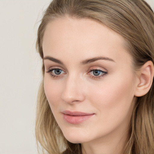 Joyful white young-adult female with long  brown hair and blue eyes