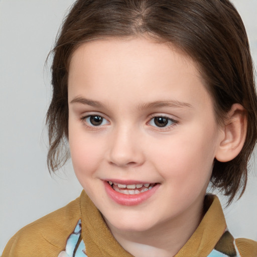 Joyful white child female with medium  brown hair and brown eyes