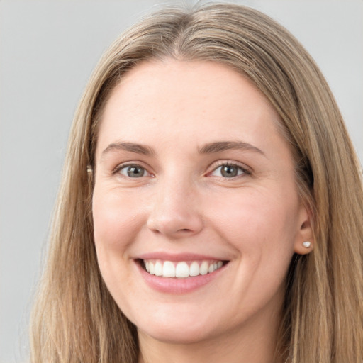 Joyful white young-adult female with long  brown hair and grey eyes