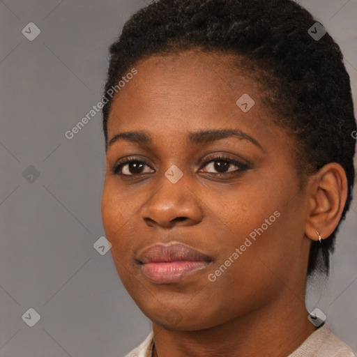 Joyful black young-adult female with short  brown hair and brown eyes