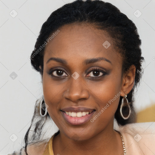 Joyful black young-adult female with long  black hair and brown eyes