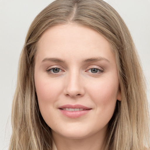 Joyful white young-adult female with long  brown hair and grey eyes