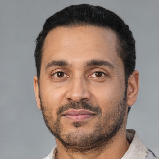 Neutral latino adult male with short  black hair and brown eyes