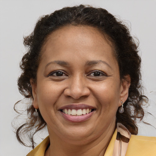 Joyful latino adult female with medium  brown hair and brown eyes