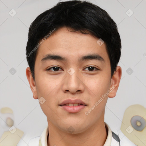 Joyful asian young-adult male with short  black hair and brown eyes