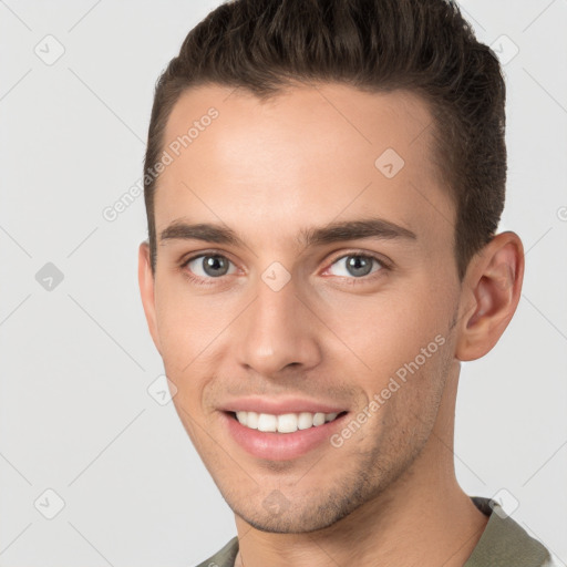 Joyful white young-adult male with short  brown hair and brown eyes