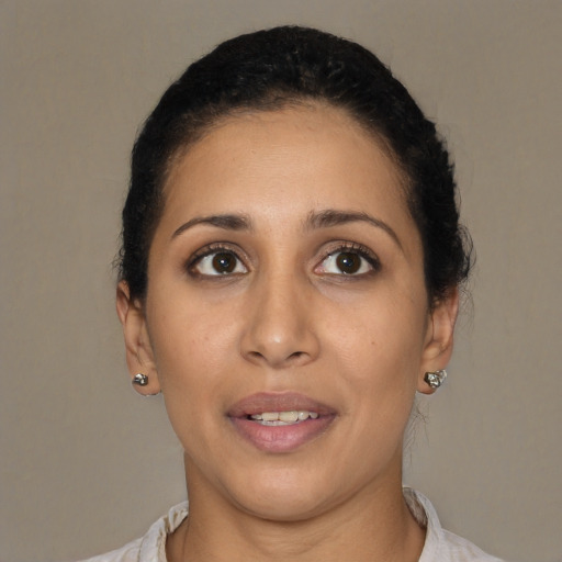 Joyful latino young-adult female with short  brown hair and brown eyes