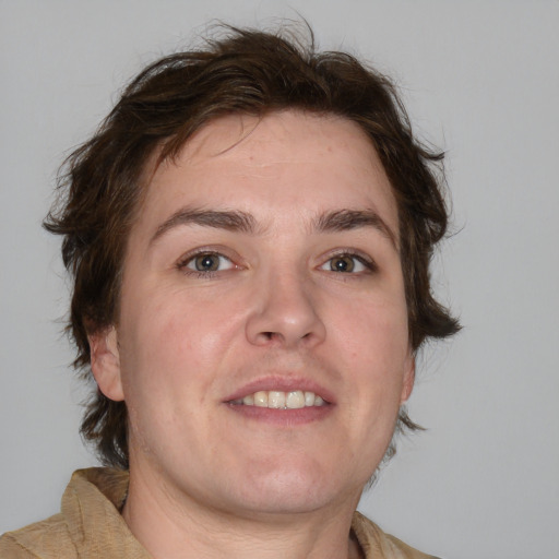 Joyful white adult male with medium  brown hair and brown eyes