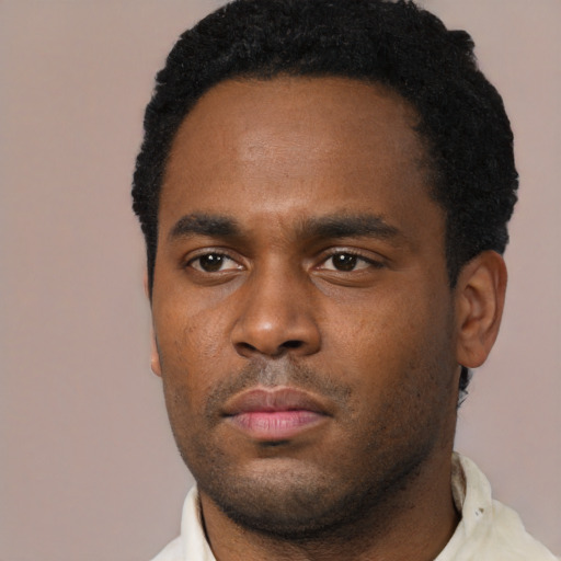 Neutral black young-adult male with short  black hair and brown eyes