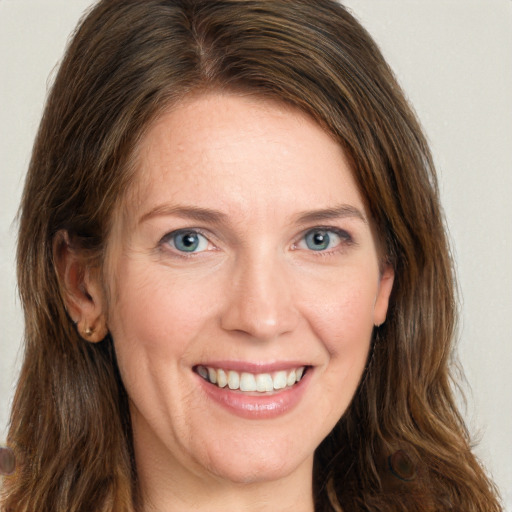 Joyful white young-adult female with long  brown hair and green eyes