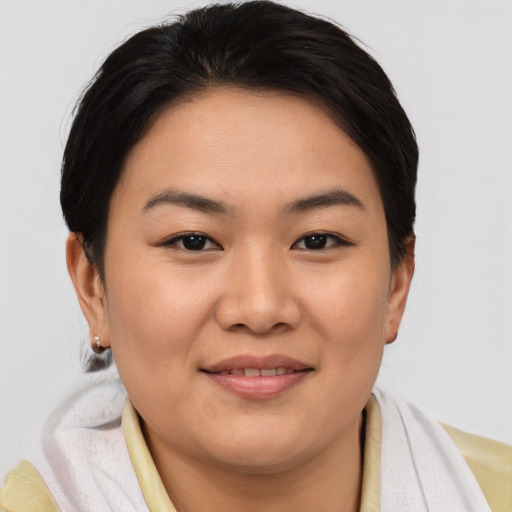 Joyful asian young-adult female with short  brown hair and brown eyes