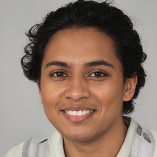 Joyful latino young-adult female with medium  brown hair and brown eyes