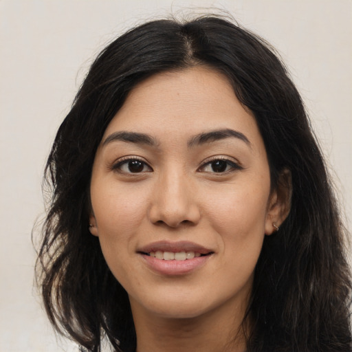 Joyful latino young-adult female with medium  black hair and brown eyes
