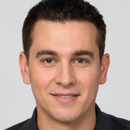 Joyful white young-adult male with short  brown hair and brown eyes