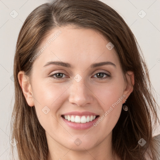 Joyful white young-adult female with long  brown hair and grey eyes