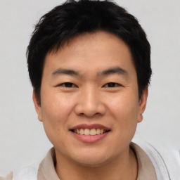 Joyful asian young-adult male with short  black hair and brown eyes