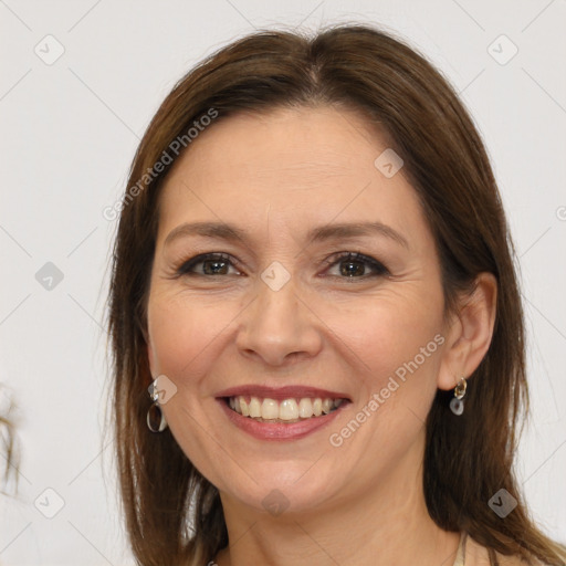 Joyful white adult female with long  brown hair and brown eyes