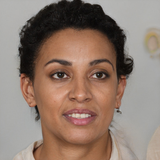 Joyful latino adult female with short  brown hair and brown eyes