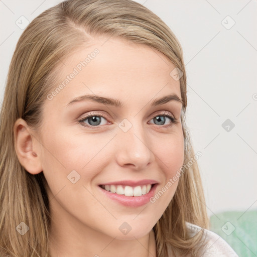 Joyful white young-adult female with long  brown hair and blue eyes