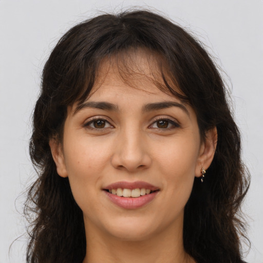 Joyful white young-adult female with long  brown hair and brown eyes