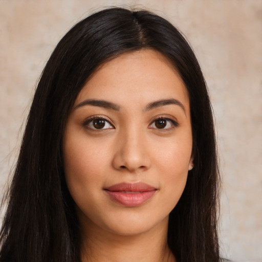 Joyful latino young-adult female with long  brown hair and brown eyes