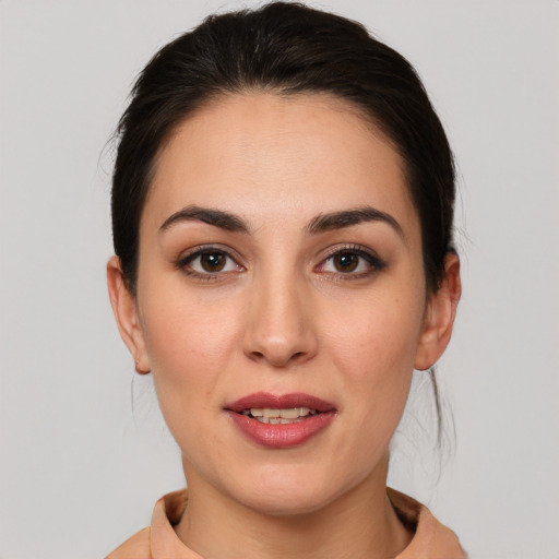 Joyful white young-adult female with medium  brown hair and brown eyes