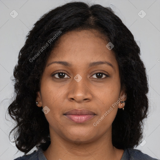 Joyful black young-adult female with long  brown hair and brown eyes