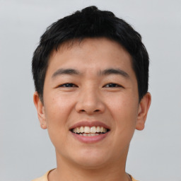 Joyful asian young-adult male with short  brown hair and brown eyes