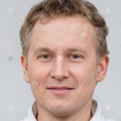 Joyful white adult male with short  brown hair and grey eyes