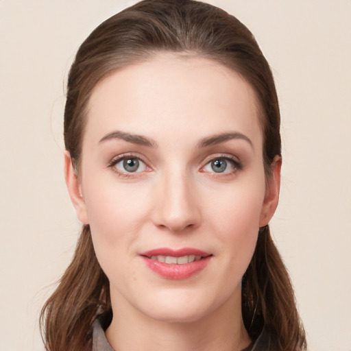 Joyful white young-adult female with long  brown hair and blue eyes