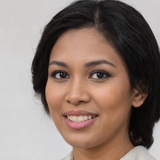 Joyful latino young-adult female with medium  black hair and brown eyes