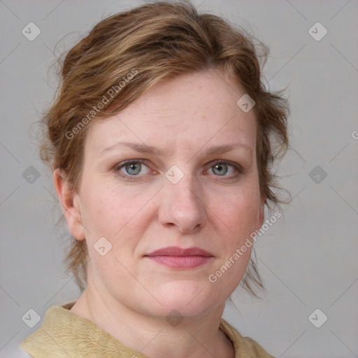 Joyful white adult female with medium  brown hair and blue eyes