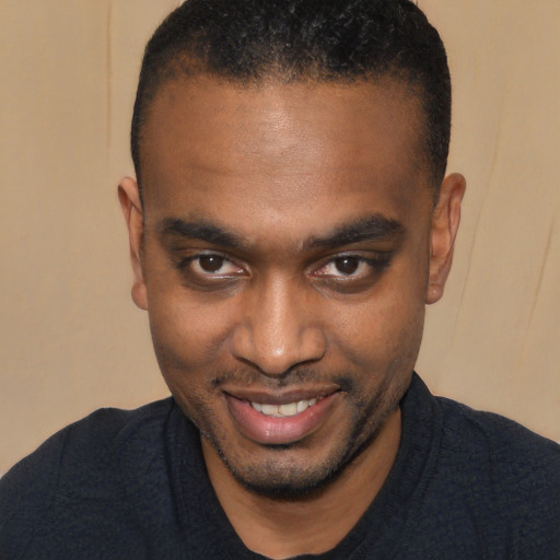 Joyful black young-adult male with short  black hair and brown eyes