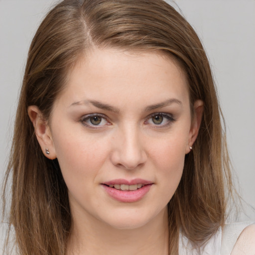 Joyful white young-adult female with long  brown hair and grey eyes