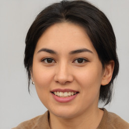 Joyful asian young-adult female with medium  brown hair and brown eyes